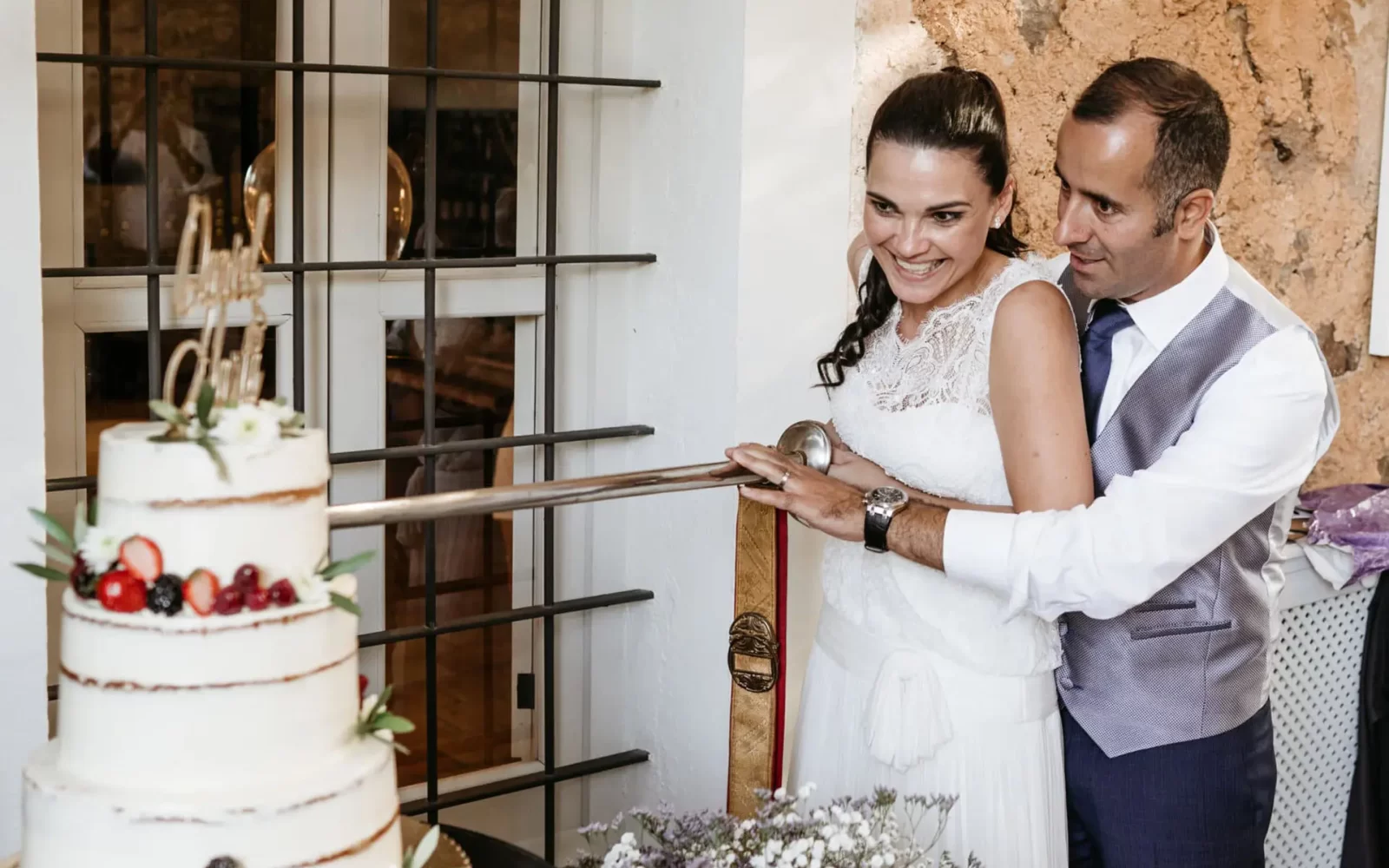 bodas-ibiza-daniel-marta-42 Bride and groom cutting Ses Escoles cake